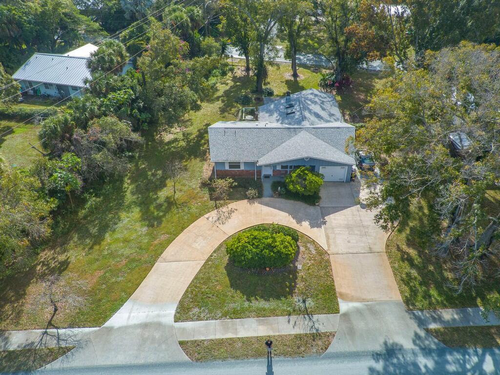 An aerial view shows a single-story house with a circular driveway and a large yard — 3105 Atlantic Boulevard, Vero Beach FL 32960, VERO BEACH, FL