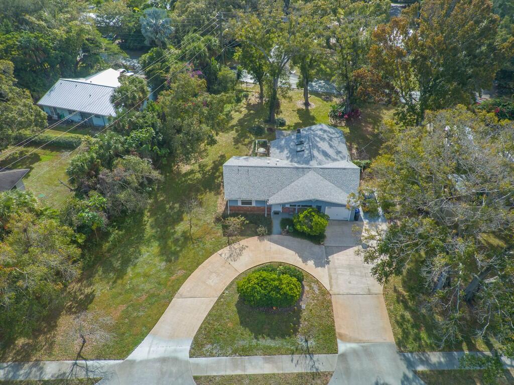 An aerial view shows a single-story house with a circular driveway and a large yard — 3105 Atlantic Boulevard, Vero Beach FL 32960, VERO BEACH, FL