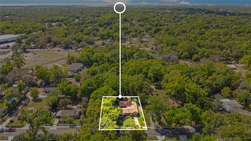 An aerial view shows a single-story house surrounded by mature trees in a residential neighborhood — 1120 SHEELER AVENUE, APOPKA, FL