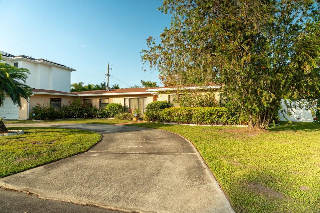 A single-story house with a beige brick exterior and a curved concrete driveway — 631 LUZON AVENUE, TAMPA, FL