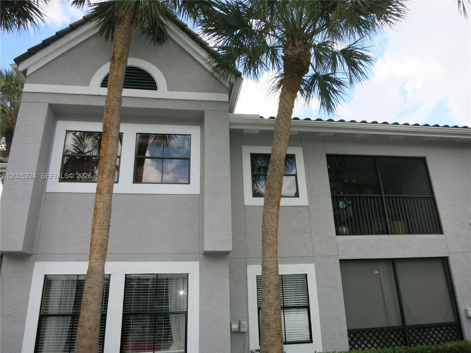 An outdoor swimming pool surrounded by a concrete deck, palm trees, and multi-story apartment buildings — 15060 SW 103rd Ter # 6203, Miami FL 33196, MIAMI, FL