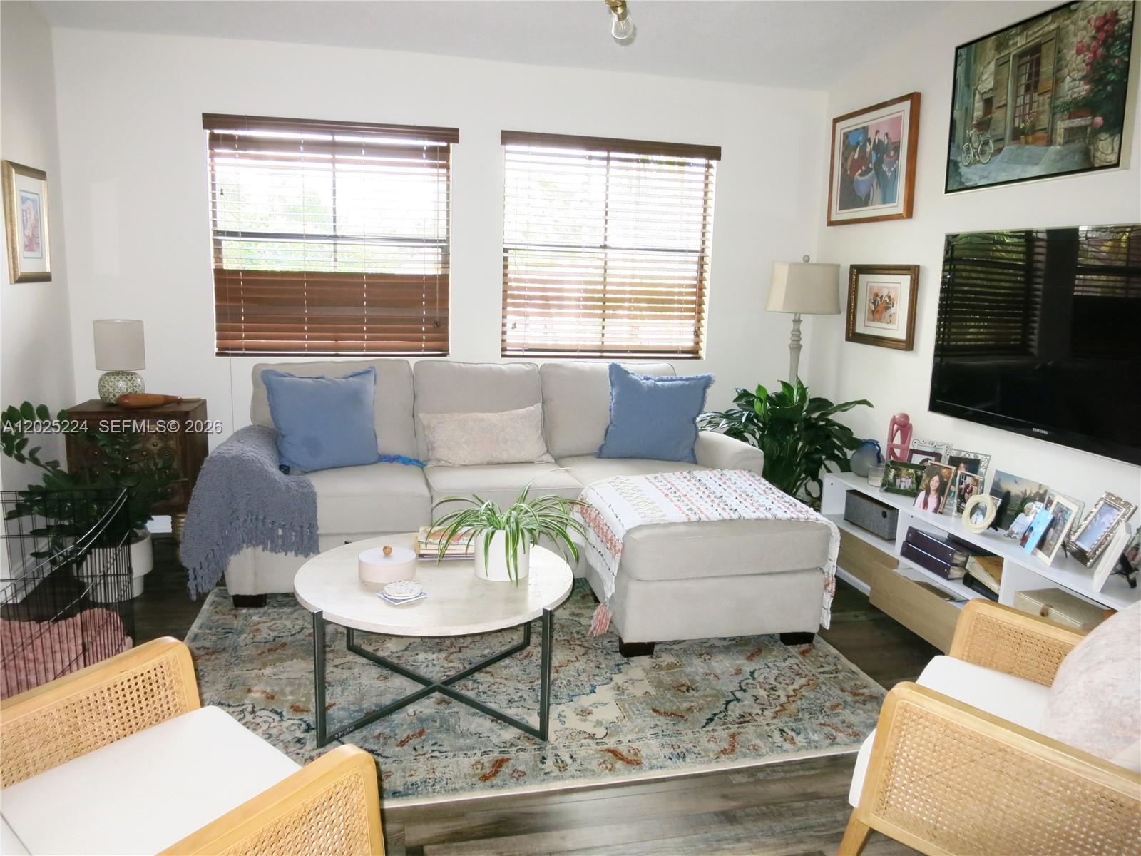 A living room features a beige sectional sofa, a round coffee table, and two chairs — 15060 SW 103rd Ter # 6203, Miami FL 33196, MIAMI, FL