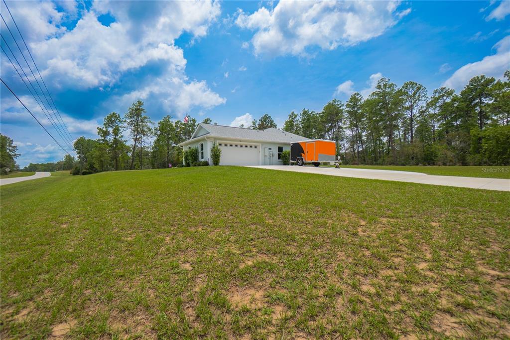 A single-story house with a white garage and an orange trailer parked on the driveway — 4136 W FINDLAY STREET, CITRUS SPRINGS, FL