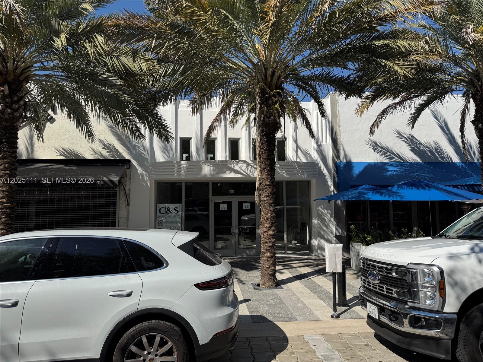 A white commercial building facade with palm trees and parked cars in front — 1929 Hollywood Blvd, Hollywood FL 33020, HOLLYWOOD, FL