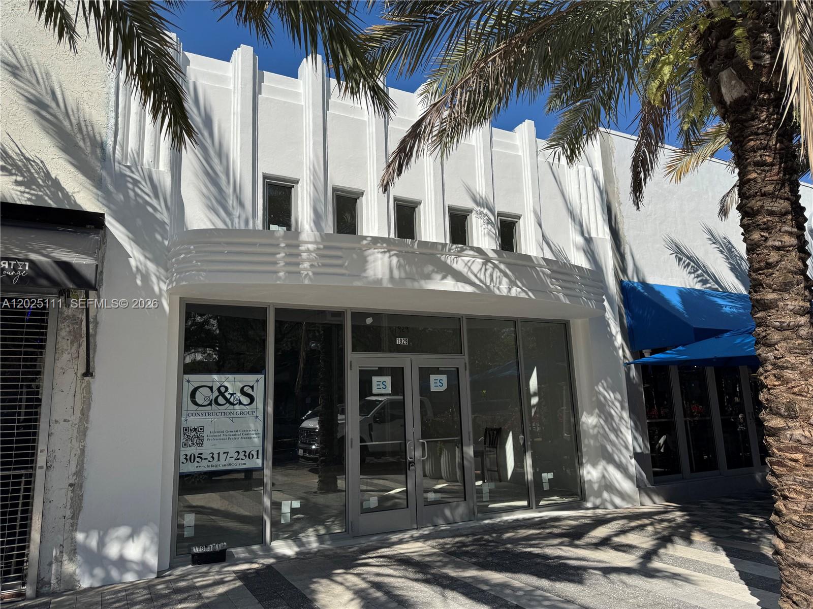 The exterior of a white commercial building features Art Deco architectural details and glass storefronts — 1929 Hollywood Blvd, Hollywood FL 33020, HOLLYWOOD, FL