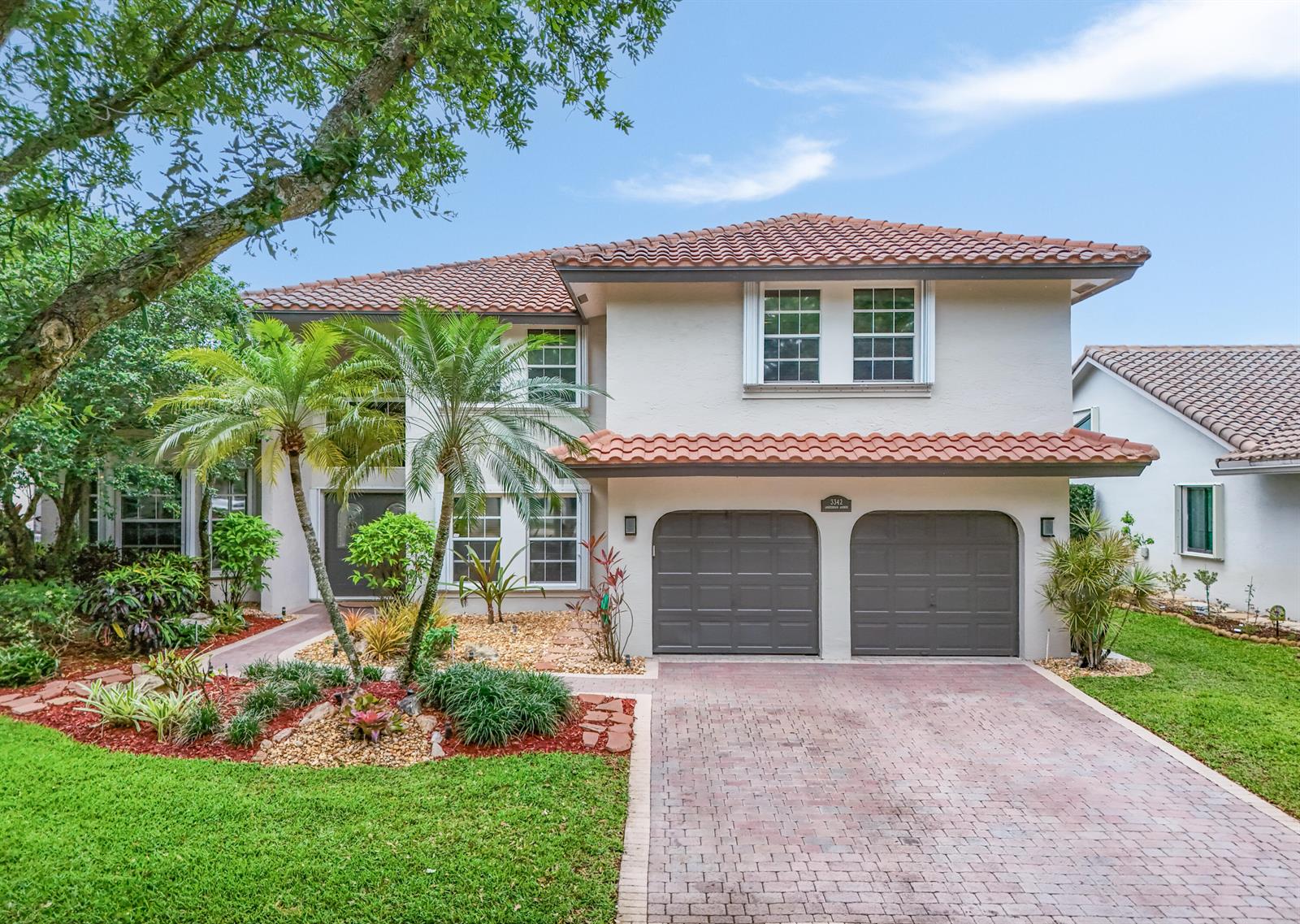 A two-story house with a tiled roof, two-car garage, and a landscaped front yard — 3342 Amsterdam Avenue, Cooper City FL 33026, COOPER CITY, FL