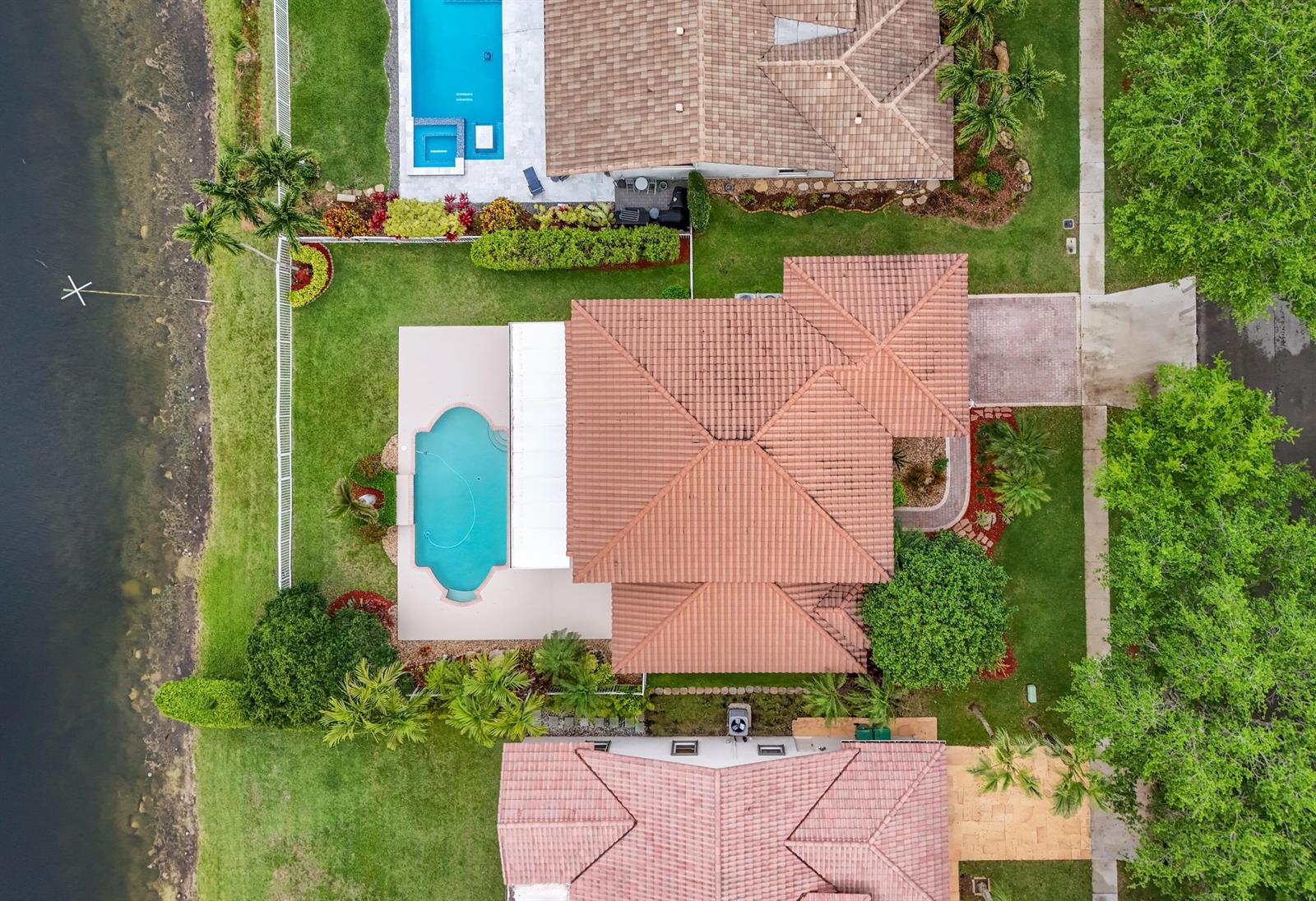 An aerial view shows a house with a tiled roof, a pool, and a backyard — 3342 Amsterdam Avenue, Cooper City FL 33026, COOPER CITY, FL