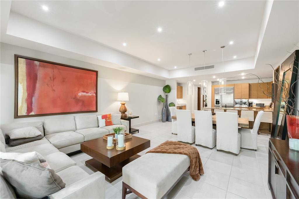 A modern open-concept living and dining area with white tile floors and neutral furniture — Bahia Beach Golf Club LAS VERANDAS CONDOMINIUM UNIT 5134, RIO GRANDE, PR