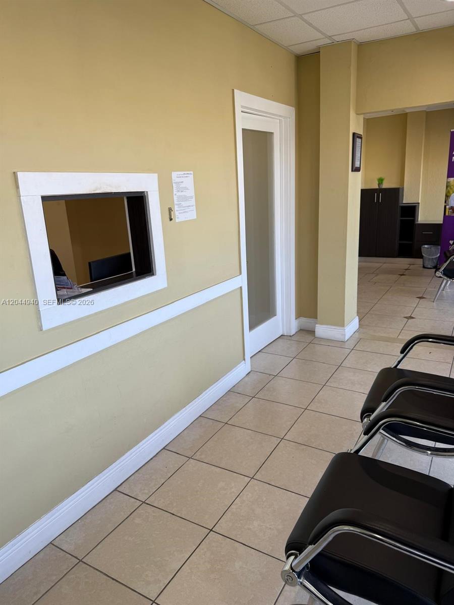 A waiting area features a service window, a glass-paneled door, and tiled flooring — 3700 W 12th Ave Suite 3762, Hialeah FL 33012, HIALEAH, FL