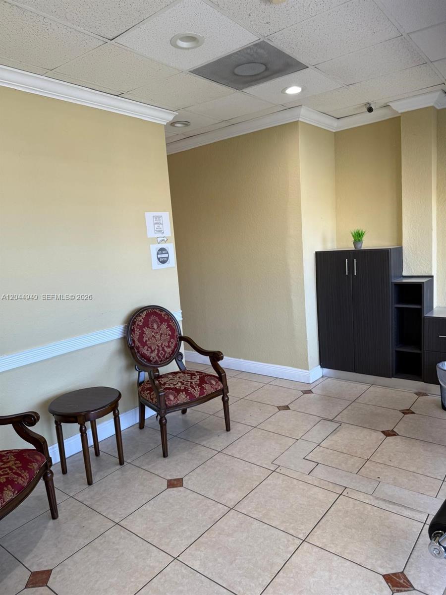 A waiting area features two patterned chairs, a small side table, and dark cabinetry — 3700 W 12th Ave Suite 3762, Hialeah FL 33012, HIALEAH, FL