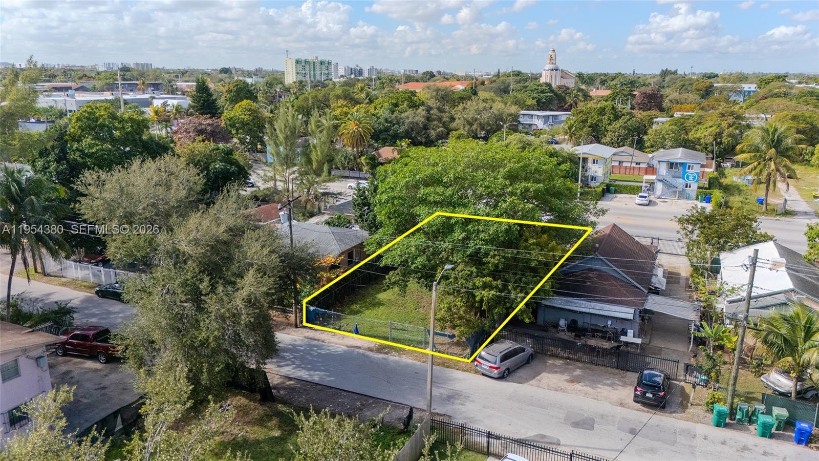 An aerial view shows a fenced, rectangular vacant lot situated between two residential buildings — 7552 NE Miami Ct, Miami FL 33138, MIAMI, FL