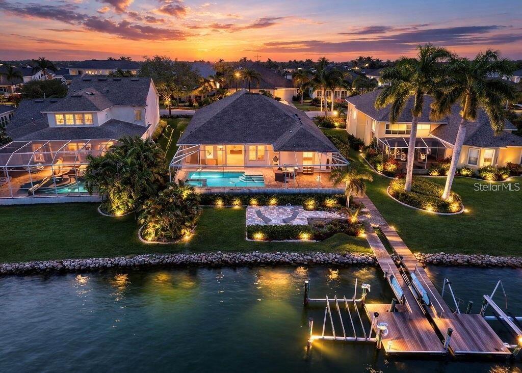 An aerial view of a waterfront house with a swimming pool, patio, and private dock — 5237 BRIGHTON SHORE DRIVE, APOLLO BEACH, FL