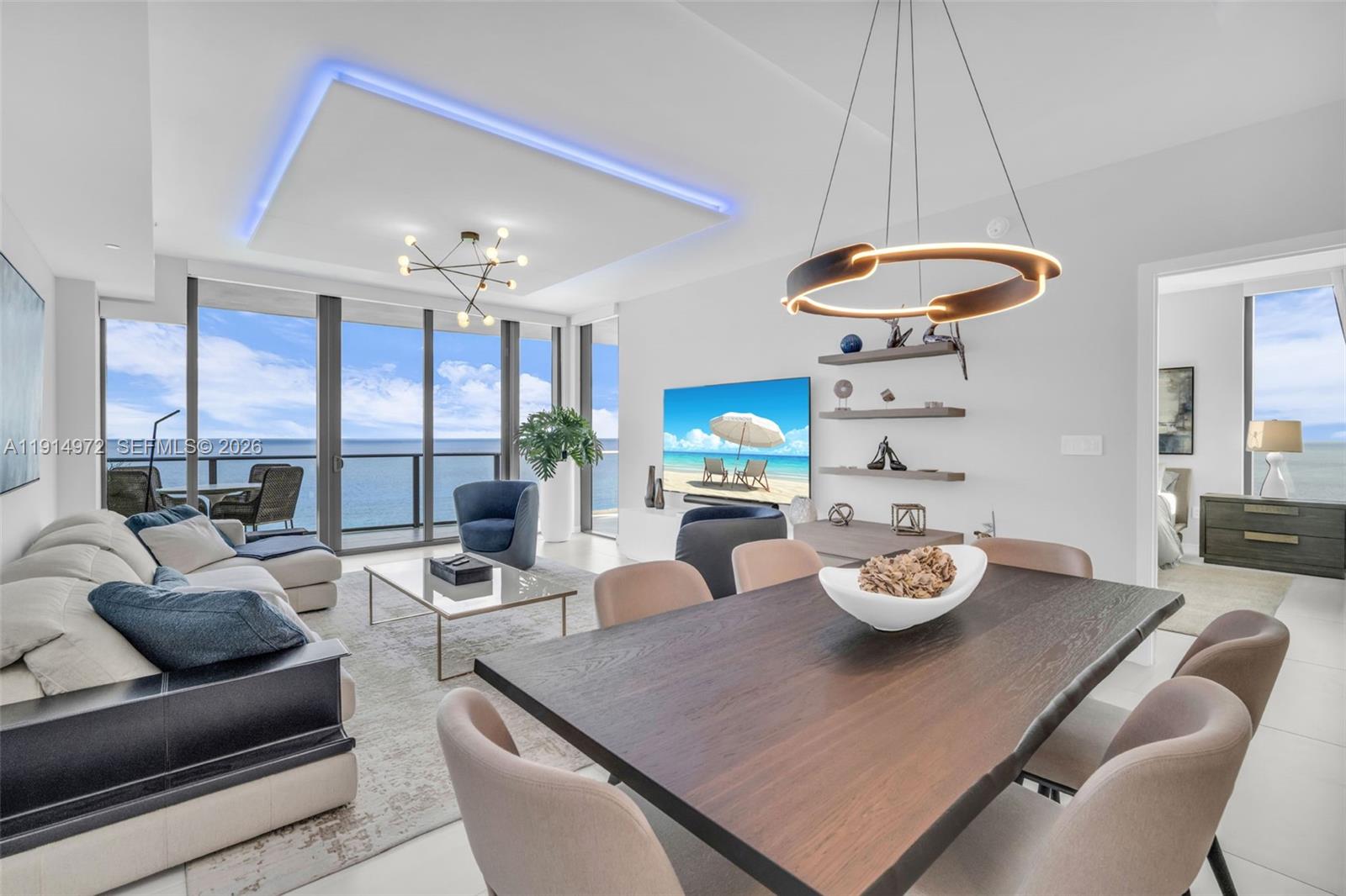 A modern living and dining area features floor-to-ceiling windows with ocean views and recessed lighting — 1116 N Ocean Blvd, Pompano Beach FL 33062, POMPANO BEACH, FL