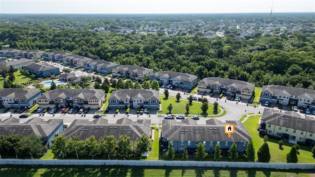 An aerial view shows multiple rows of townhomes with gray roofs and green lawns — 2840 WHITE ISLE LN, ORLANDO, FL