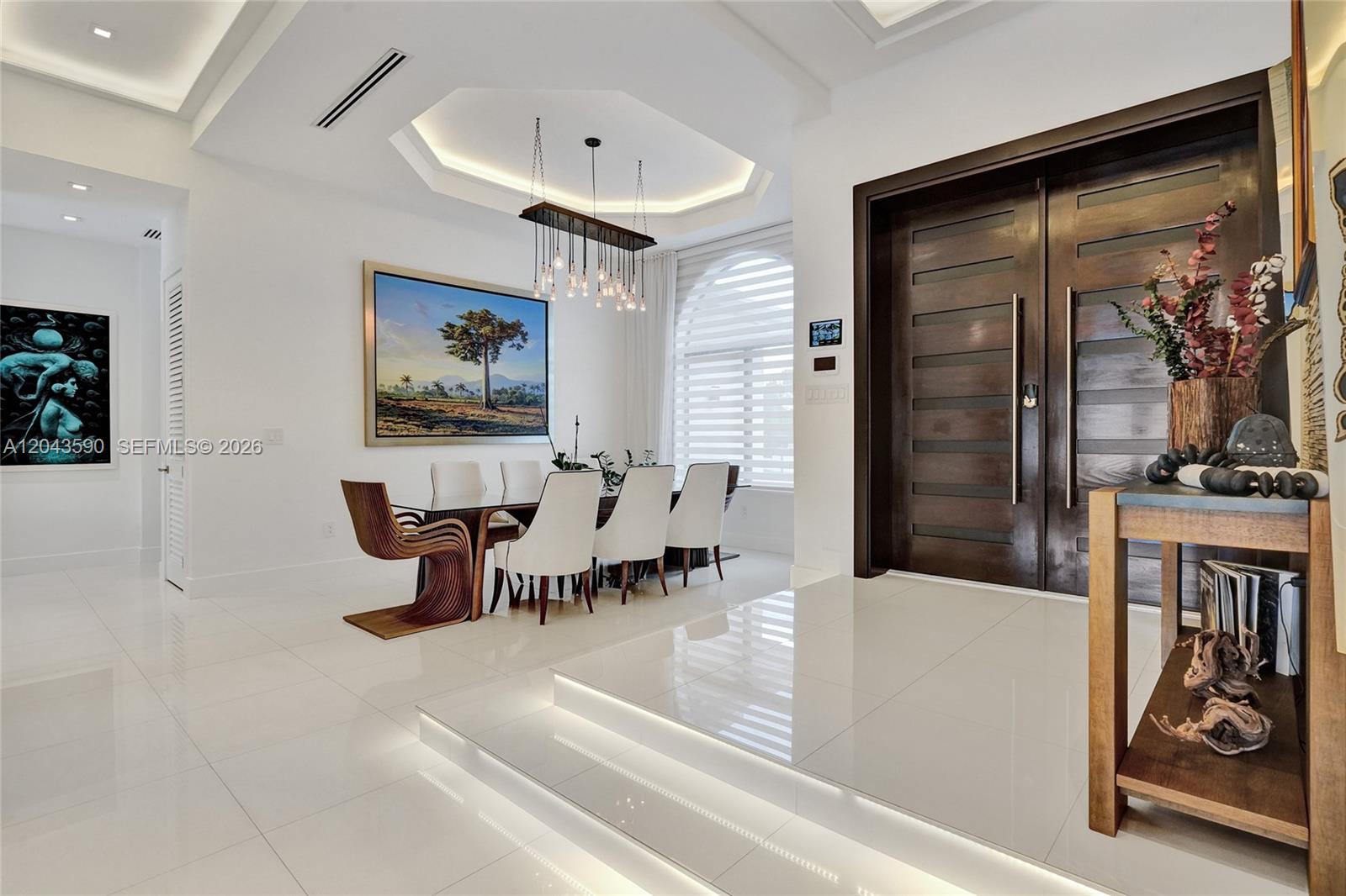 A dining room features a tiered floor with LED lighting, white chairs, and a wooden table — 2600 SW 128th Ct, Miami FL 33175, MIAMI, FL