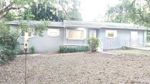 A single-story gray house with a shingled roof sits behind a dirt yard — 3214 DIAN ROAD, TALLAHASSEE, FL