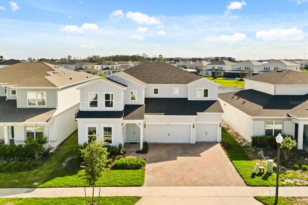 A two-story suburban house with a white exterior, dark roof, and a paved driveway — 8352 PARK CLIFF WAY, ORLANDO, FL