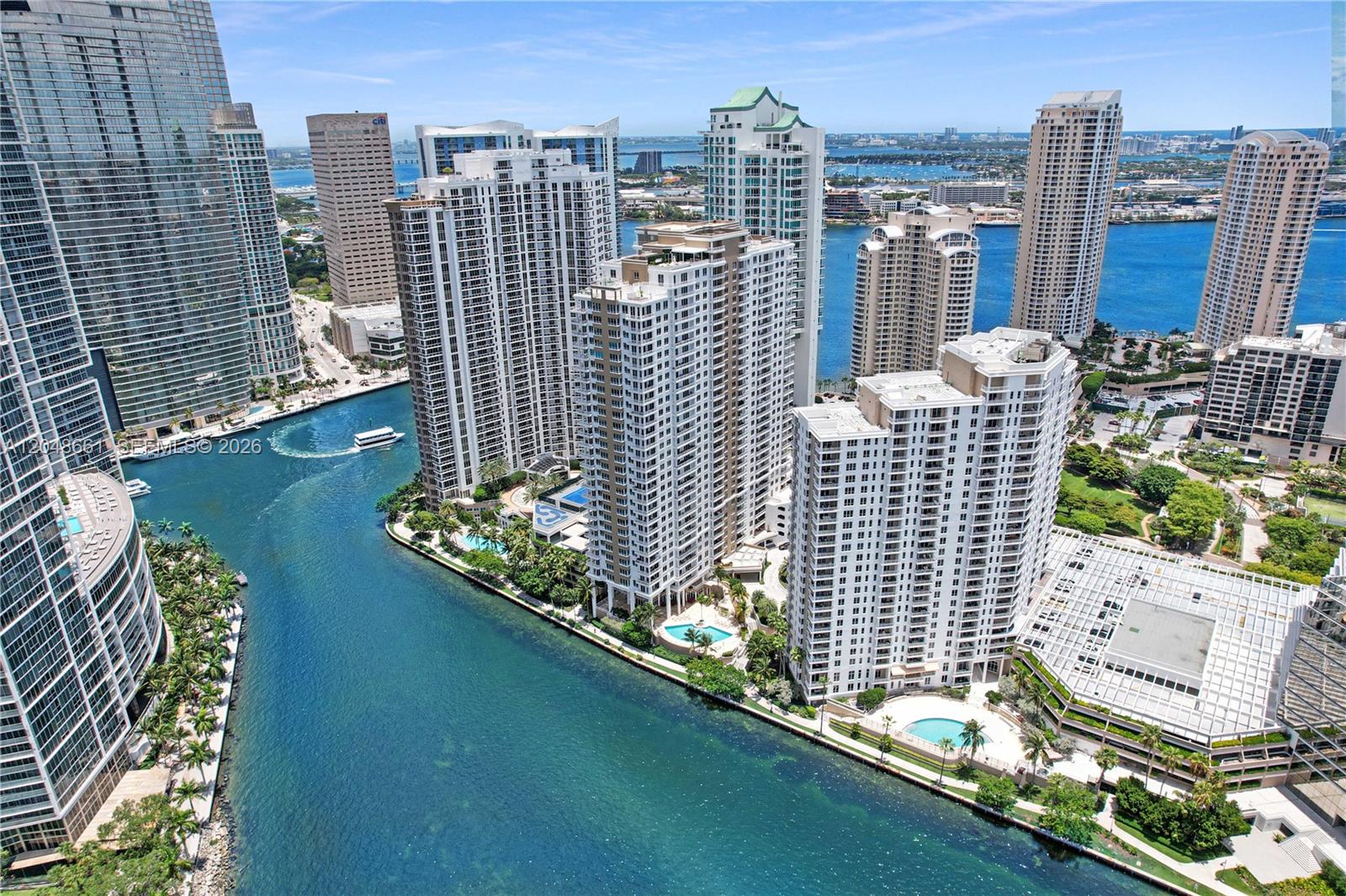 An aerial view of high-rise apartment buildings situated along a canal in a coastal city — 801 Brickell Key Blvd # 2210, Miami FL 33131, MIAMI, FL