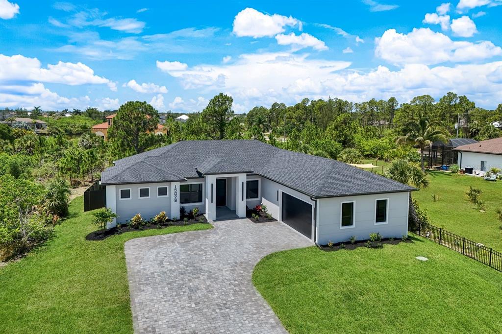 An aerial view of a single-story house with a gray roof and a paved driveway — 15029 ACORN CIRCLE, PORT CHARLOTTE, FL