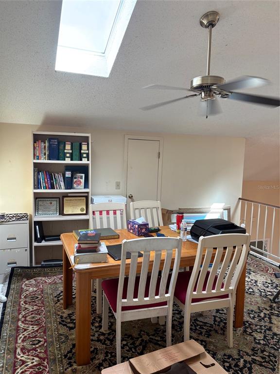 A dining area features a wooden table, white chairs, a bookshelf, and a ceiling fan — 2336 SUN VALLEY CIRCLE BLDG 20, WINTER PARK, FL