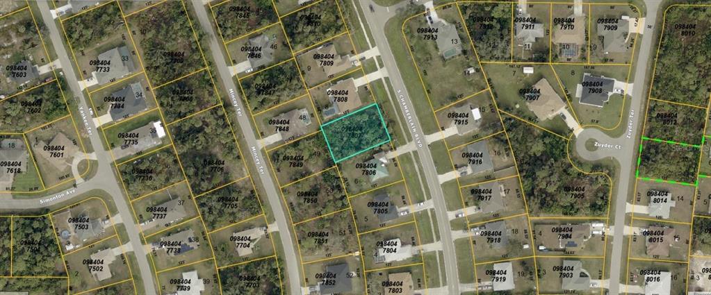 This is an aerial map showing a vacant lot highlighted in blue among residential properties — S CHAMBERLAIN BOULEVARD, NORTH PORT, FL