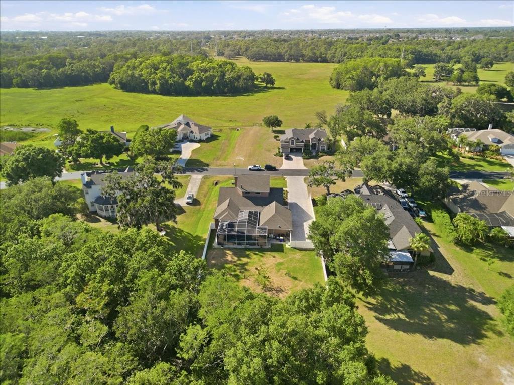 A two-story house with a covered front porch, stone accents, and a paved walkway — 2818 SHIPSTON AVENUE, NEW PORT RICHEY, FL