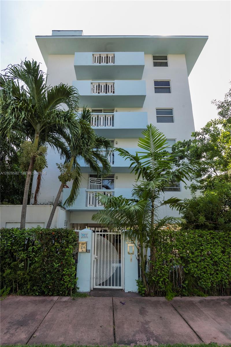 A multi-story apartment building features light blue balconies and a gated entrance behind palm trees — 301 Jefferson Ave # 4E, Miami Beach FL 33139, MIAMI BEACH, FL