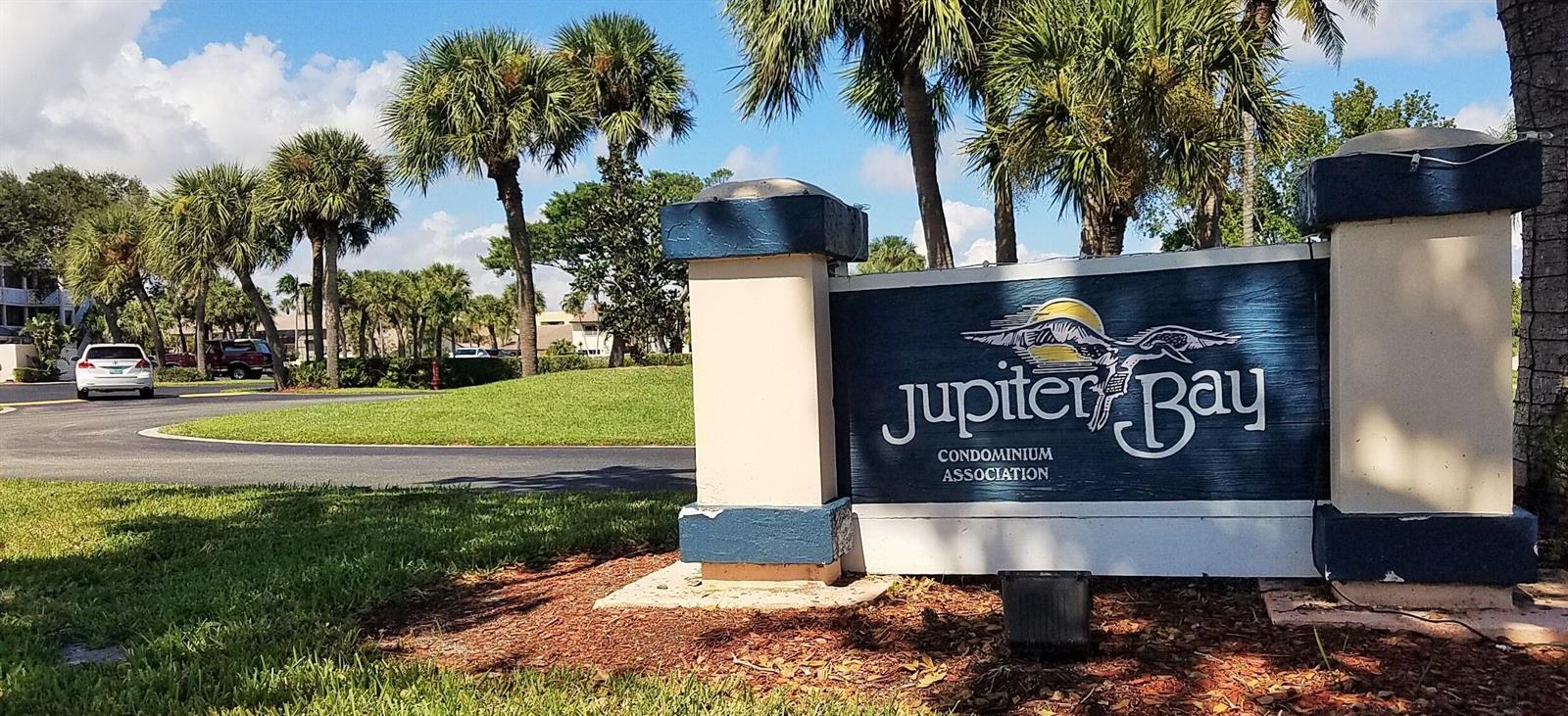 A sign for the Jupiter Bay Condominium Association stands in a landscaped area with palm trees — 353 S Us Highway 1 # A407, Jupiter FL 33477, JUPITER, FL