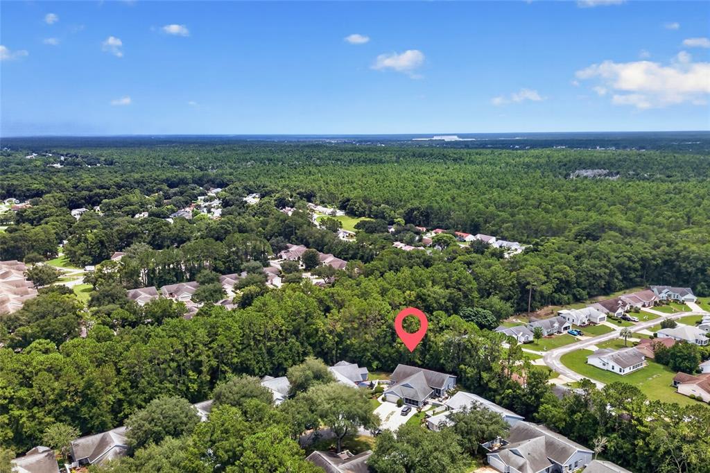 An aerial view shows a suburban neighborhood with a red location pin over a house — 8055 SW 115TH LOOP, OCALA, FL