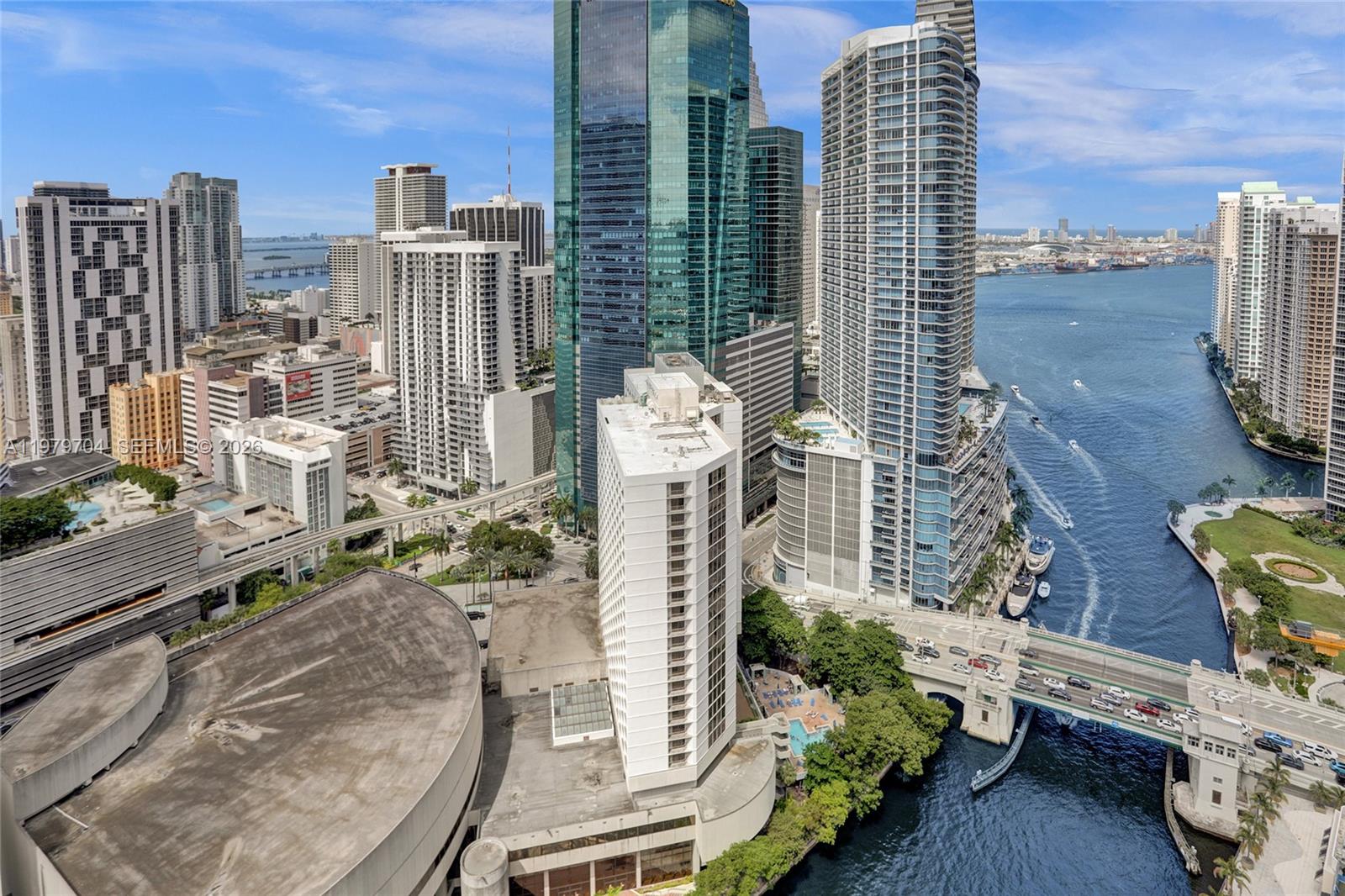 An aerial view of a dense urban waterfront skyline with high-rise buildings and a bridge — 31 SE 5th St # 4112, Miami FL 33131, MIAMI, FL