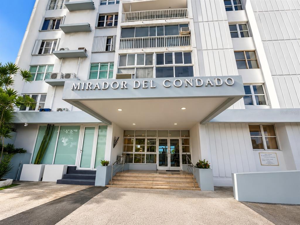 The exterior entrance of the Mirador del Condado apartment building features a covered walkway — 1035 ASHFORD AVE UNIT 802, SAN JUAN, PR