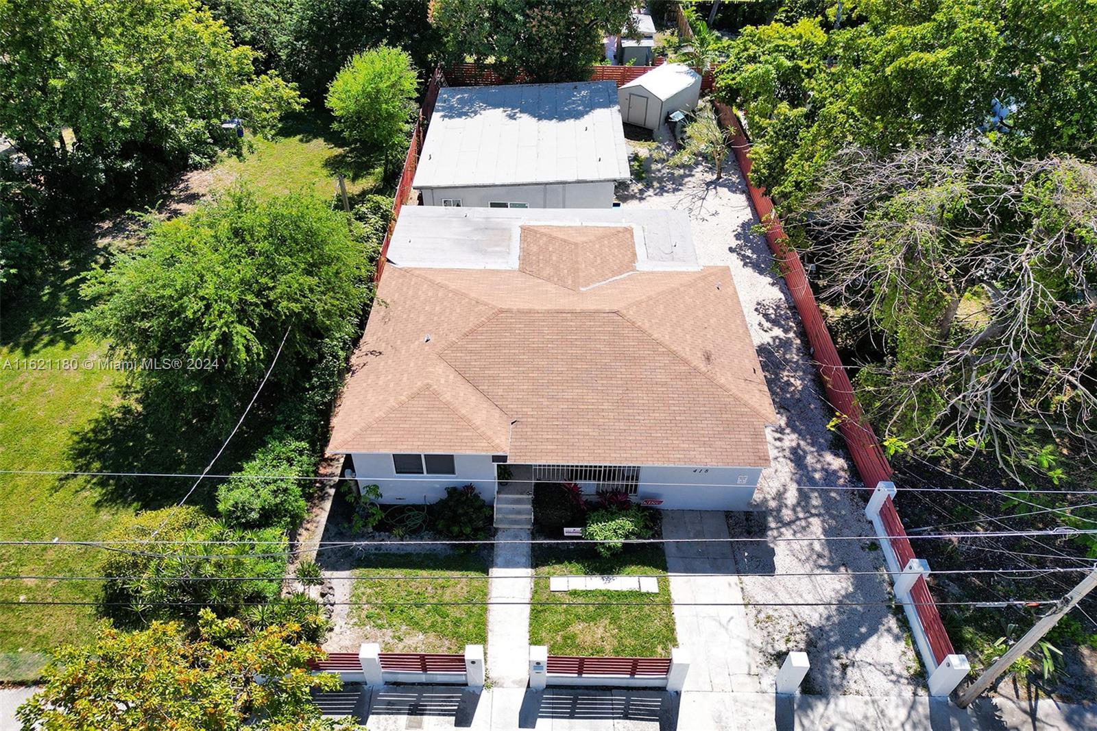 An aerial view shows a single-story house with a brown roof and a detached shed — 418 NW 47th St, Miami FL 33127, MIAMI, FL