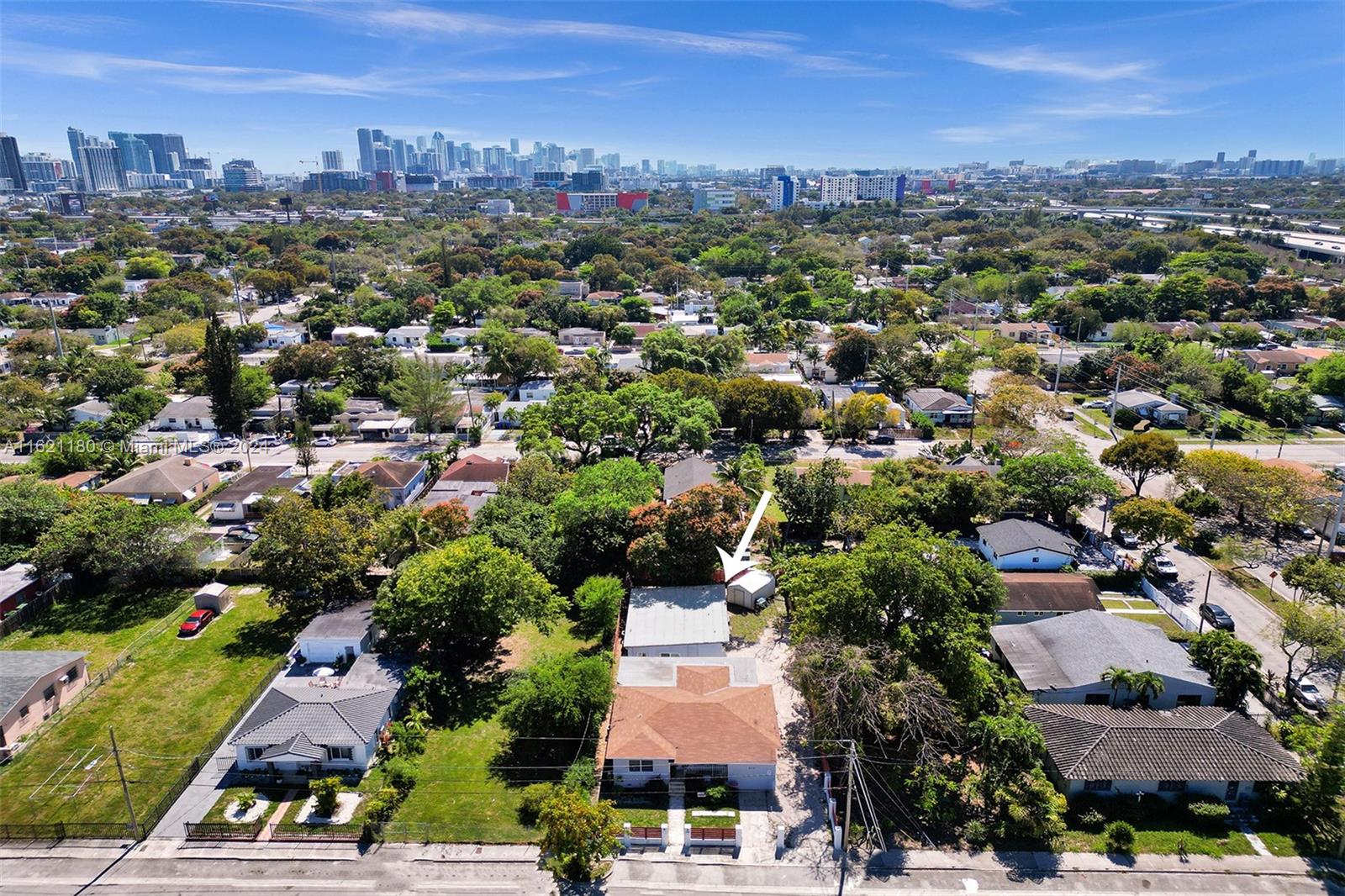 An aerial view shows a single-story house with a brown roof and a detached shed — 418 NW 47th St, Miami FL 33127, MIAMI, FL