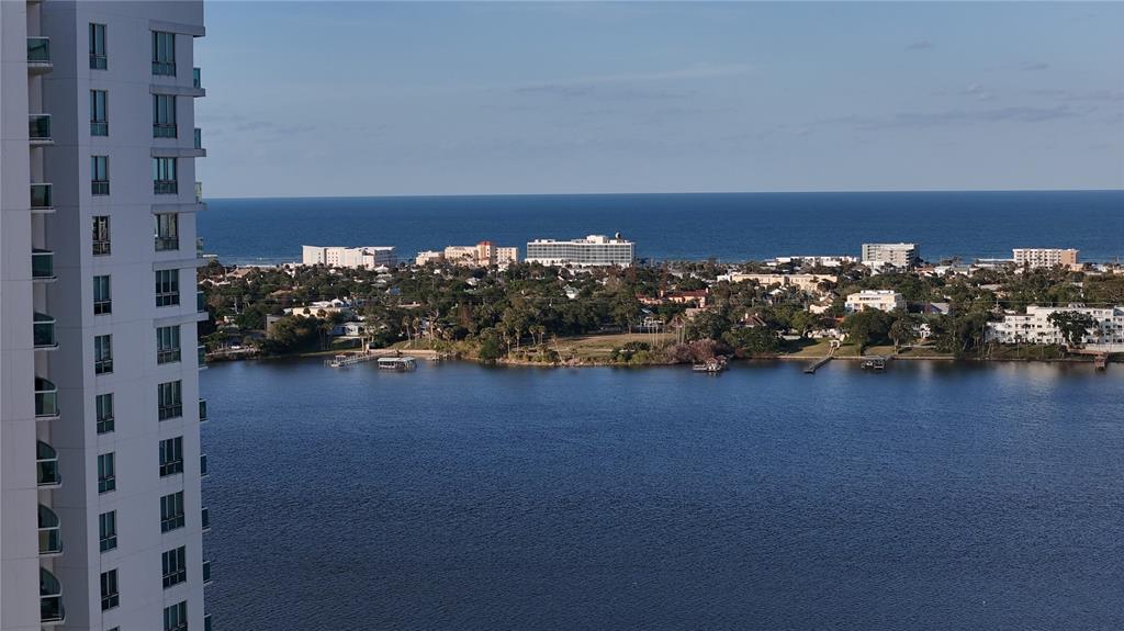 An elevated view of a high-rise building overlooking a body of water and the ocean — 231 RIVERSIDE DRIVE UNIT 1110, DAYTONA BEACH, FL