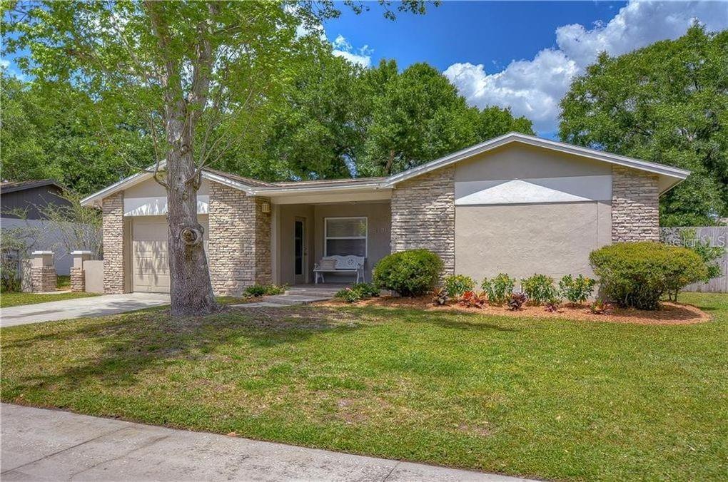A single-story house with a stone facade, a front porch, and a concrete driveway — 5121 ELLENDALE AVENUE, TAMPA, FL