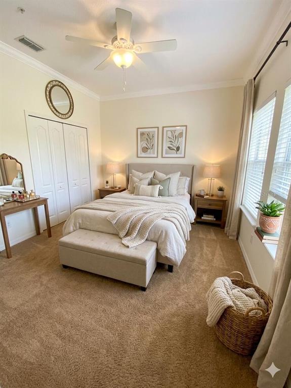 A bedroom features a queen bed, a storage bench, two nightstands, and a vanity — 10230 LAKE DISTRICT LANE UNIT 37B, ORLANDO, FL