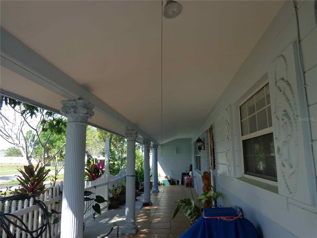 A kitchen features white cabinets, stainless steel appliances, and light-colored tile flooring — 6165 26TH AVENUE N, ST PETERSBURG, FL