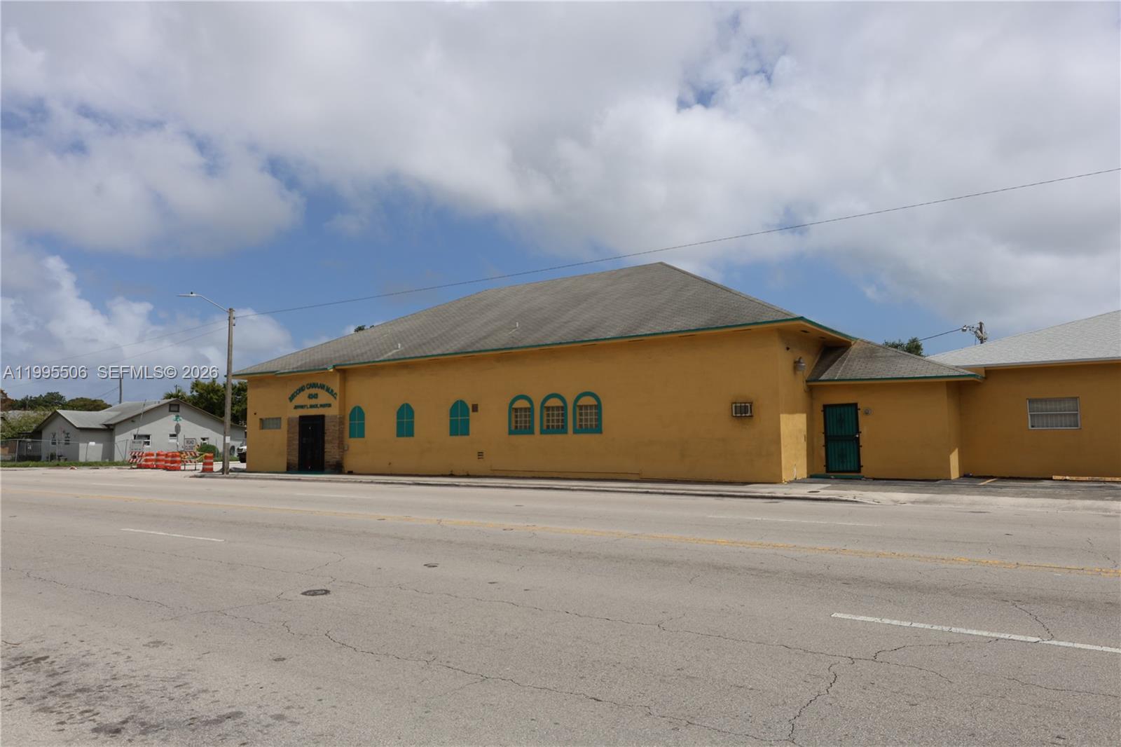 A yellow, single-story church building with arched windows sits along a paved road — 4343 NW 17th Ave, Miami FL 33142, MIAMI, FL