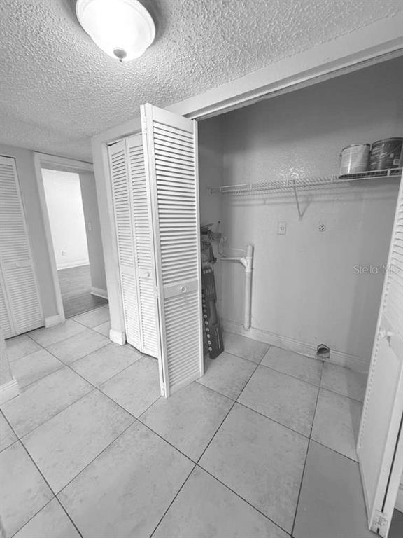 A laundry closet with louvered doors, tile flooring, and plumbing hookups for a washer and dryer — 4767 S TEXAS AVENUE UNIT 4767B, ORLANDO, FL