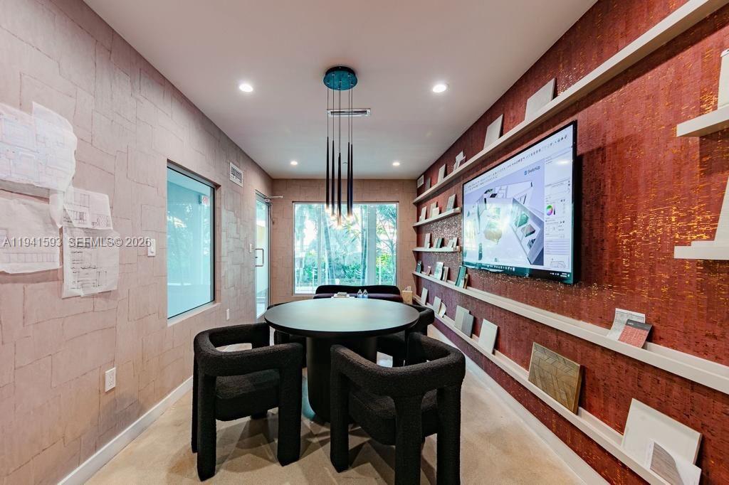 A modern conference room features a round table, black chairs, and wall-mounted shelving — 350 S Miami Ave, Miami FL 33130, MIAMI, FL