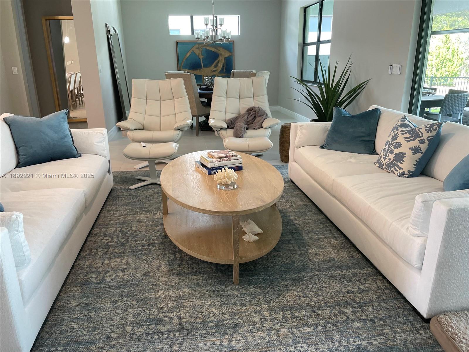 A living room features two white sofas, two matching armchairs, and a wooden coffee table — 4960 Surfside Circle, Bradenton FL 34211, BRADENTON, FL