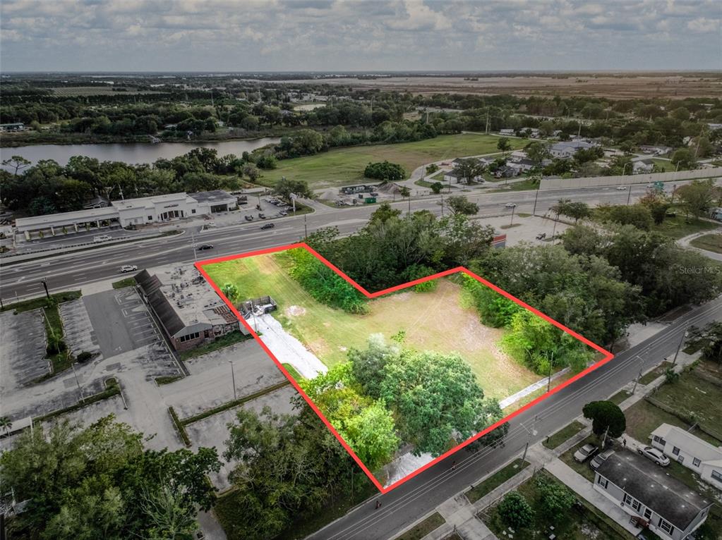 An aerial view shows a vacant, L-shaped lot outlined in red between two paved roads — 0 W STATE ROAD 60, LAKE WALES, FL