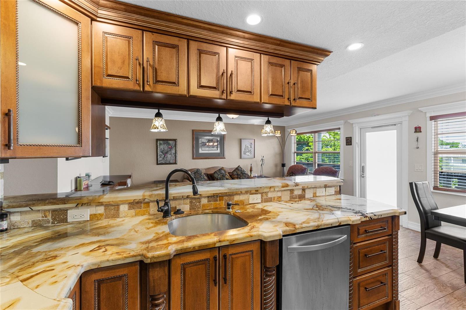 A kitchen features wood cabinets, a stone countertop, a stainless steel sink, and a dishwasher — 417 Richmond C # 417, Deerfield Beach FL 33442, DEERFIELD BEACH, FL