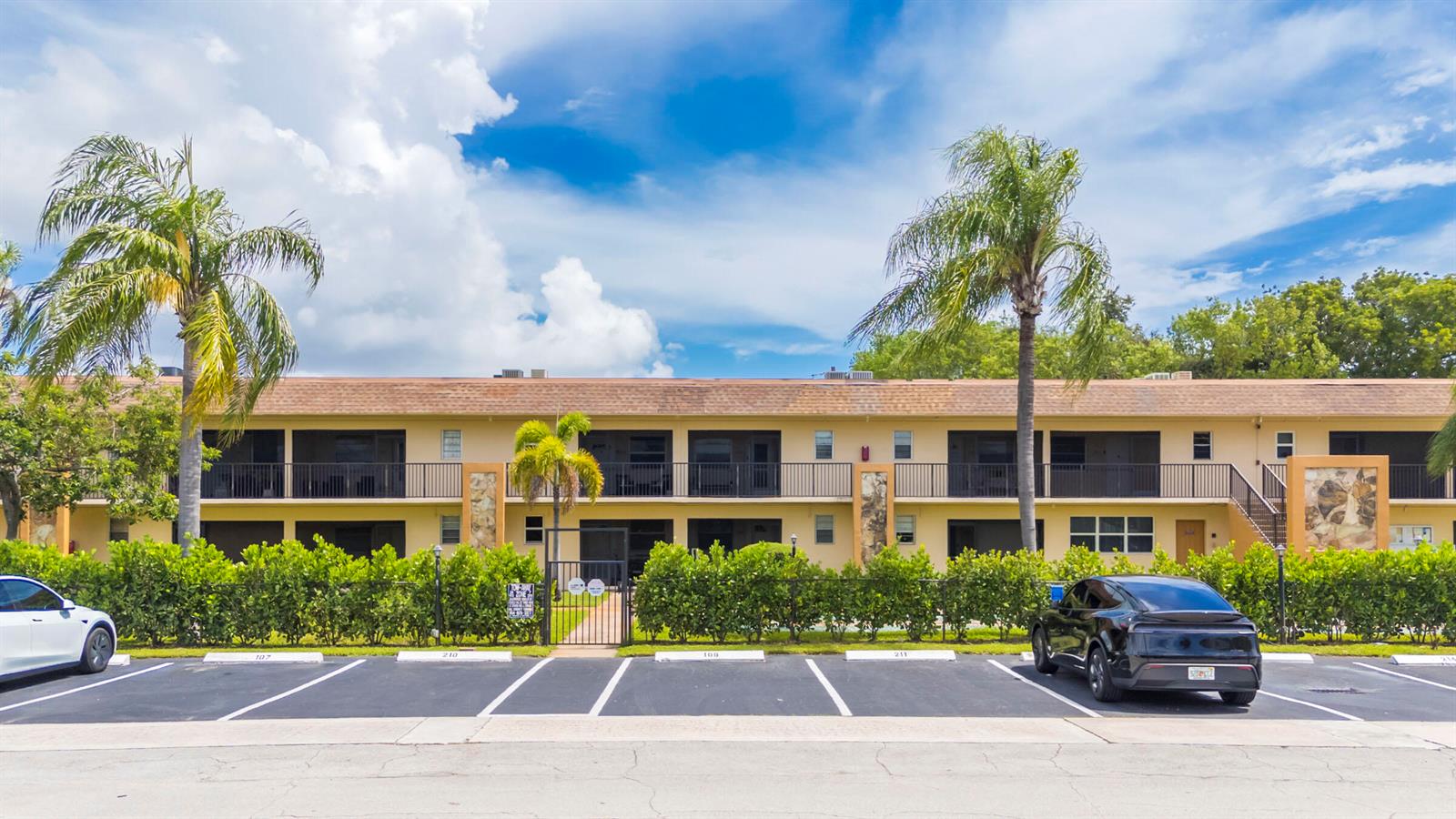 A two-story apartment building with a parking lot in front and two palm trees — 421 NE 1ST Street # 204, Hallandale Beach FL 33009, HALLANDALE BEACH, FL