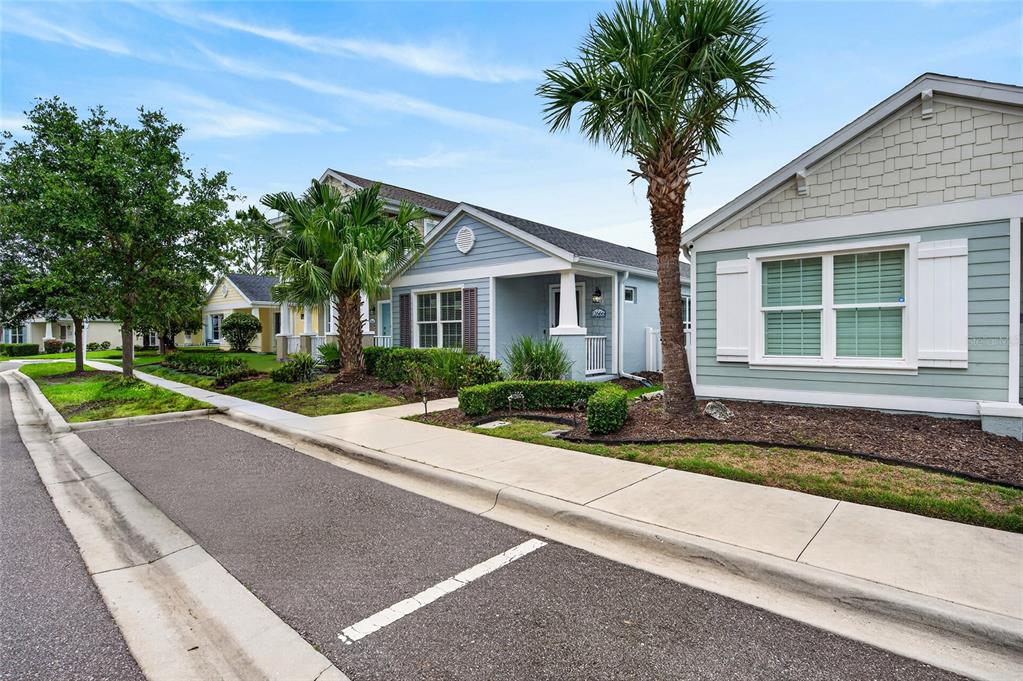 A street view shows several single-story houses with light-colored siding and palm trees — 12666 SHIMMERING OAK CIRCLE, VENICE, FL