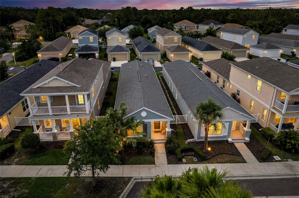 An aerial view shows a suburban neighborhood with multiple single-family houses and paved streets — 12666 SHIMMERING OAK CIRCLE, VENICE, FL