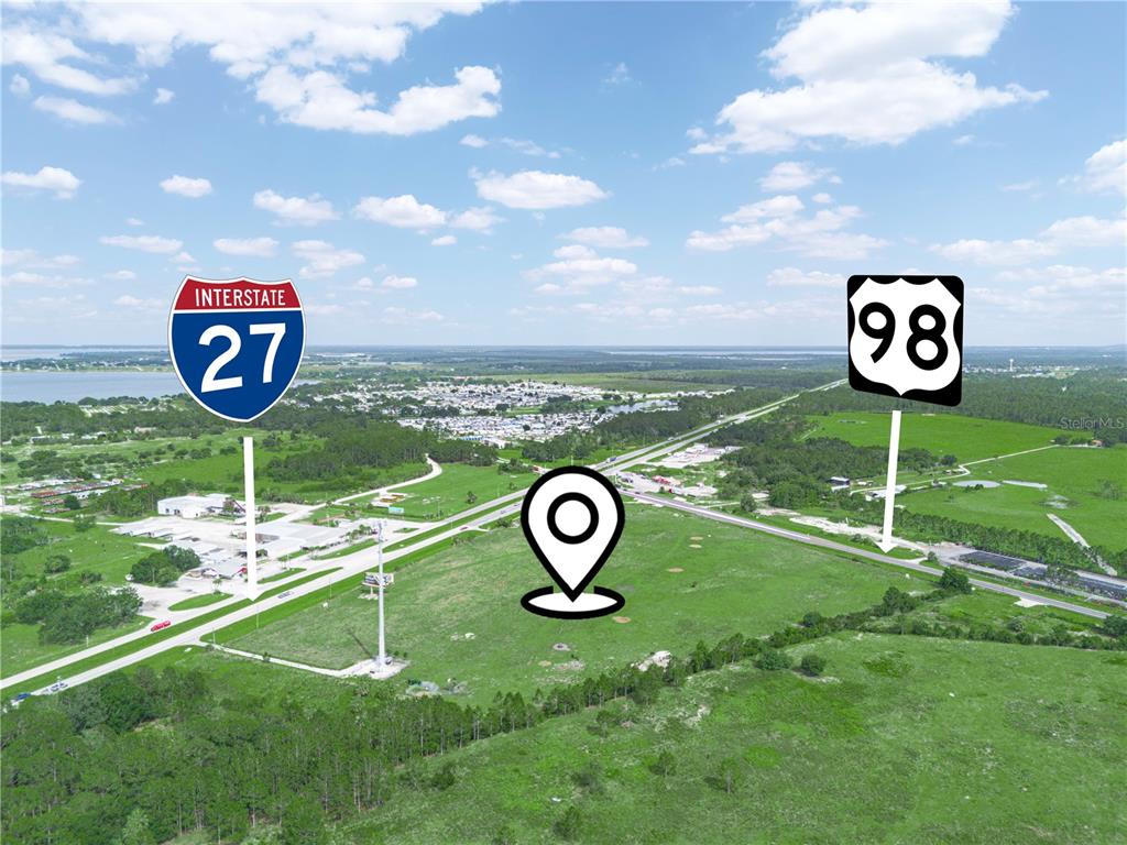 This is an aerial view of a grassy lot near highway intersections — 7316 HWY 27, FROSTPROOF, FL
