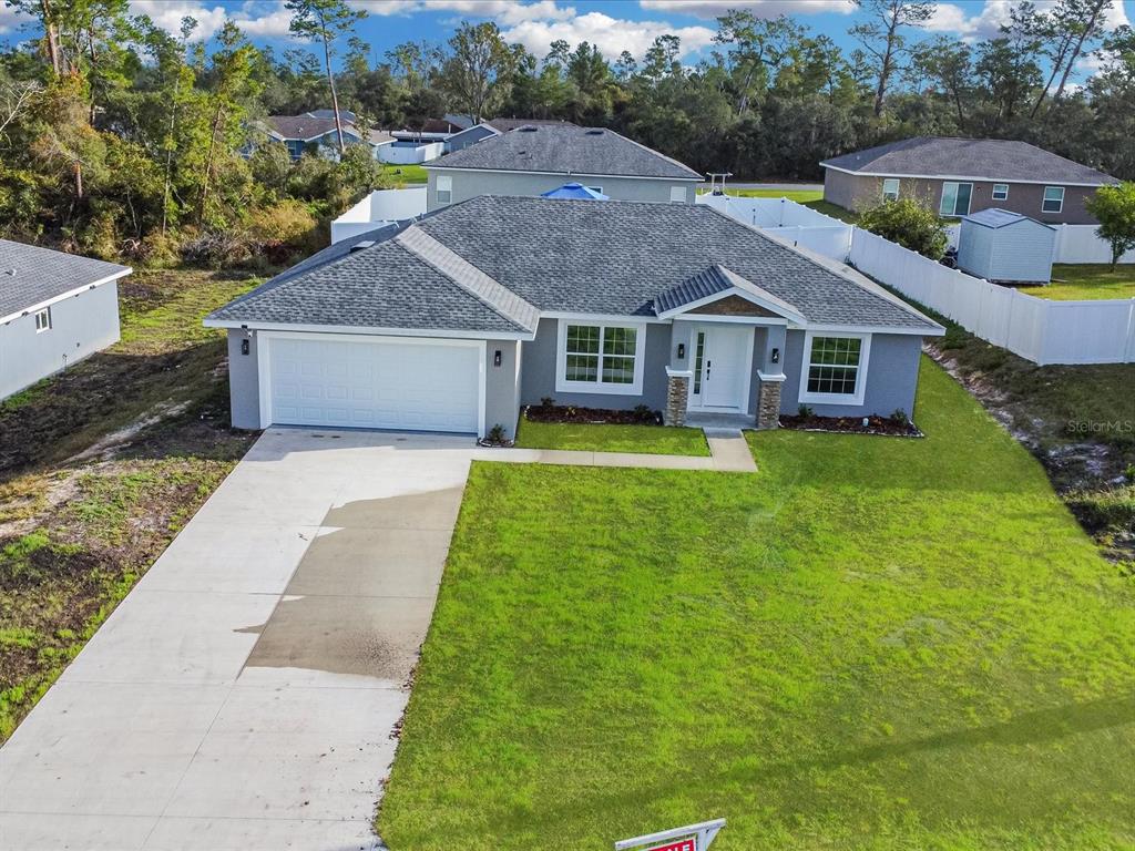 An aerial view of a single-story gray house with a two-car garage and lawn — 16619 SW 31ST CIRCLE, OCALA, FL