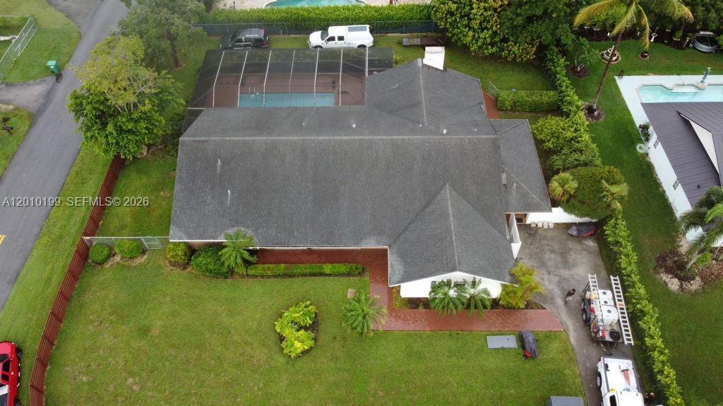 An aerial view shows a house with a dark shingled roof and a screened pool — 29490 SW 193 AVE, Homestead FL 33030, HOMESTEAD, FL