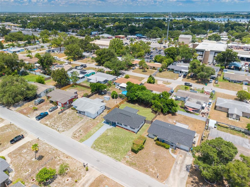An aerial view shows a suburban neighborhood with single-story houses, driveways, and surrounding trees — 11189 108TH WAY, LARGO, FL
